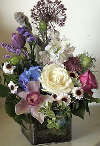 Every day arrangement made of roses, orchids, alstroemeria and tulips coloured